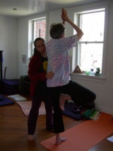 Bobbi helping student with a Tree Pose