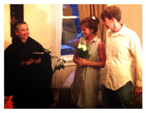 Bobbi with young couple at a home wedding