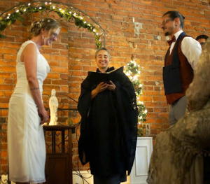 Bobbi and couple enjoying a happy moment during a wedding ceremony