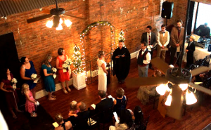 Full view of large wedding with bridesmaids, groom's men and guests
